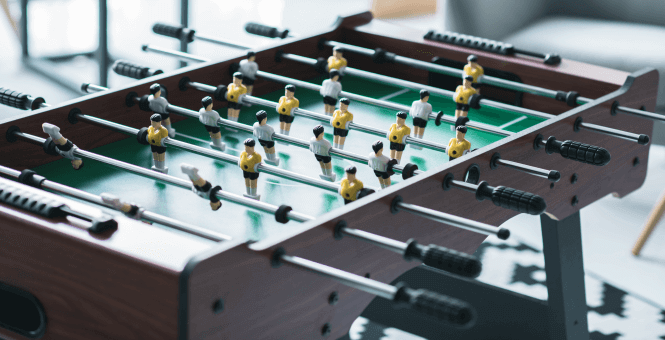 A close up of a foosball table
