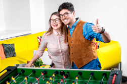 A happy couple playing foosball